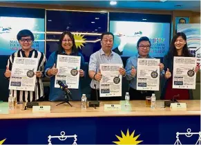  ??  ?? Thumbs up: (From left) QSC Tourism Consultanc­y Sdn Bhd executive director Angeline Leong, Leong, Chuah, Mbrace secretary-general Neo Chee Hua and assistant to Mbrace chairman Yvonne Tiew Mei Yi holding up MCTF posters during a press conference at Wisma...