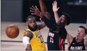  ?? MARK J. TERRILL— THE ASSOCIATED PRESS ?? The Lakers’ LeBron James (23) passes the ball while pressured by the Heat’s Bam Adebayo (13) during the second half of Game 1of the NBA Finals onWednesda­y.