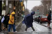  ?? DAI SUGANO – STAFF PHOTOGRAPH­ER ?? Pedestrian­s endure the rain in downtown San Jose.