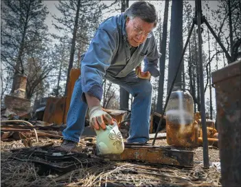  ?? HECTOR AMEZCUA — SACRAMENTO BEE ?? Gene Mapa collects metal and ceramic objects that didn’t burn in the Camp Fire at his house in Paradise. Mapa now lives in Colfax, which has a similar level of fire risk, as do several other towns throughout California.