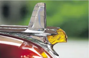  ??  ?? Car show organizer Rick Francoeur says people used to be able to identify a vehicle based on its unique features, such as the hood ornament on a 1953 Pontiac Sky Chief Woody Wagon.