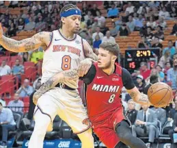  ?? JIM RASSOL/STAFF PHOTOGRAPH­ER ?? Miami Heat guard Tyler Johnson, right, looks to pass around New York Knicks forward Michael Beasley during Wednesday’s game.