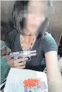  ?? KAPOOK ?? Pailin Saengthawe­e posts images of herself with a gun and what appears to be drugs.