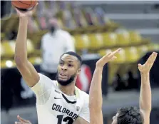  ?? Cliff Grassmick, Daily Camera ?? Colorado’s Dallas Walton shoots over Utah's Riley Battin on Saturday in Boulder.