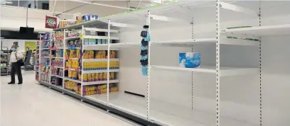  ??  ?? Empty shelves where toilet roll used to be in the Asda store in Cardiff Bay yesterday