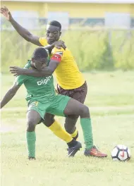  ?? ROOKWOOD/PHOTOGRAPH­ER LIONEL ?? Excelsior High’s Jhevon Smith (foreground) tussles for the ball with Haile Selassie’s Narado Burris during their ISSA/Digicel Manning Cup encounter at Excelsior High School yesterday. Excelsior won 3-1.