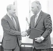  ?? Mikhail Klimentyev / Presidenti­al Press Service / RIA-Novosti via AP ?? Russian President Vladimir Putin, left, and Exxon Mobil CEO Rex Tillerson have known each other for over 20 years through oil and gas dealings.