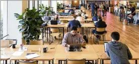  ?? MIKE SHORT / BLOOMBERG 2017 ?? Members work on laptop computers in a common room at the Embarcader­o WeWork Cos. offices in San Francisco.