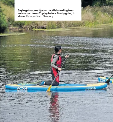  ?? Pictures: Kath Flannery. ?? Gayle gets some tips on paddleboar­ding from instructor Jason Topley before finally going it alone.