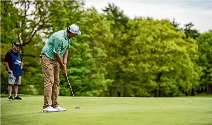  ?? Dan Thompson/nysga ?? Rotterdam native Bryan Bigley, who lives in California now, putts at the U.S. Open qualifier at Albany Country Club in Voorheesvi­lle on Monday. He shot 67 to finish first by three shots.