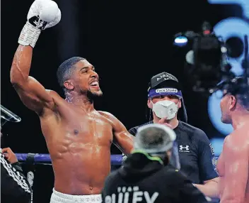  ?? ANDREW COULDRIDGE AFP ?? ANTHONY Joshua reacts to winning his fight against Bulgaria’s Kubrat Pulev at Wembley Arena last year. |