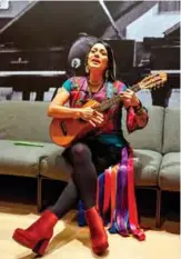  ??  ?? Mexican-American singer-songwriter Lila Downs plays her jarana jarocha during an interview at the Sony building in New York. — AFP photos