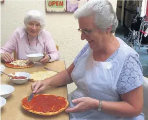  ??  ?? ●● Resident Betty Hall, left, crafts handmade pizza with Parklands activity co-ordinator Denise Gleaves