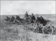  ?? THE ASSOCIATED PRESS ?? A Belgian machine gun detachment aims near Haelen, with a dog pulling a cart in August 1914. The Belgians used dogs to draw these guns and ammunition­s. They were messengers, spies, sentinels and the heavy haulers of World War I, carrying supplies, munitions and food and leading cavalry charges. The horses, mules, dogs and pigeons were a vital part of the Allied war machine, saving countless lives — and dying by the millions.