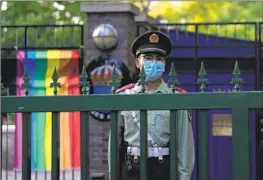  ?? Ng Han Guan Associated Press ?? A CHINESE paramilita­ry police officer stands guard outside the Swedish Embassy during the opening ceremony for Diversity Week in Beijing on Friday.