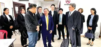  ?? ?? Dr Sim (front, centre) seen with others at Kuching Court Complex after the proceeding­s. On his left is Shankar.