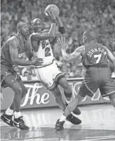  ?? JOHN SWART/AP ?? The Bulls’ Michael Jordan, center, slips between the Suns’ Mark West, left, and Kevin Johnson in the first quarter of Game 3 of the NBA Finals on June 13, 1993.