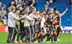  ?? ?? Sheriff Tiraspol players and staff are on cloud nine after their shock victory over Real Madrid in the Champions League