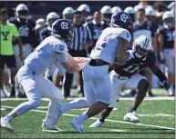  ?? Icon Sportswire via Getty Images ?? Yale Bulldogs defensive back Dathan Hickey (11) reads the play and makes a quick tackle on Holy Cross Crusaders running back Jordan Fuller (23) during the game on Sept. 18 at the Yale Bowl in New Haven.