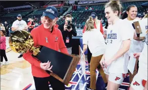  ?? Matt Rourke / Associated Press ?? Fairfield coach Joe Frager looks at the trophy after defeating Manhattan 73-68 in the MAAC championsh­ip game on Saturday in Atlantic City, N.J.