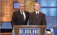  ?? Jeopardy Production­s / TNS ?? “Jeopardy!” host Alex Trebek, left, poses with contestant Ken Jennings after his earnings from his record-breaking streak on the game show surpassed $1 million, on July 14, 2004.