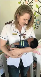  ?? Picture:SUPPLIED ?? MOTHERLY LOVE: Midwife of ABC Family Clinic, Marisce Blackaller Smal, holds one of the babies at the Breath of Life Place of Safety Organisati­on