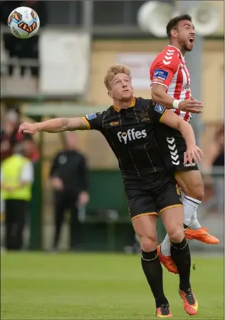  ??  ?? John Mountney challenges Daren Cole.