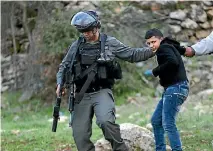  ?? PHOTO: REUTERS ?? An Israeli border policeman detains a Palestinia­n protester during clashes near Israel’s Ofer Prison near the West Bank city of Ramallah earlier this month.