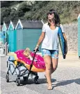  ??  ?? A mother and daughter feeling the heat on Bournemout­h beach yesterday