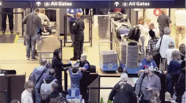  ?? PAM PANCHAK Pittsburgh Post-Gazette via AP ?? Transporta­tion Security Administra­tion officers check passengers through security at the Pittsburgh Internatio­nal Airport.