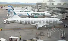  ?? DAVID ZALUBOWSKI, AP ?? Frontier Airlines jets are tended to at Denver Internatio­nal.