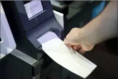  ?? MATT ROURKE - THE ASSOCIATED PRESS ?? In this June 13file photo, an Investigat­or with the Office of the City Commission­ers, demonstrat­es the ExpressVot­e XL voting machine at the Reading Terminal Market in Philadelph­ia.