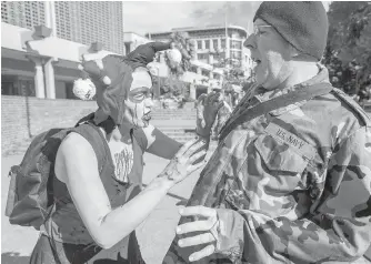  ??  ?? Evie Frederick and David McEwan hammed it up for the cameras while getting in the mood for the Victoria Zombie Walk before it got under way.