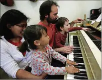  ?? BOB CHAMBERLIN / LOS ANGELES TIMES / TNS ?? According to a new study conducted by MIT and researcher­s in Beijing, musical training may have more of an impact on a child’s languagele­arning skills than extra reading lessons. Learning piano specifical­ly helped children who are developing their vocabulary with speech-sound processing.