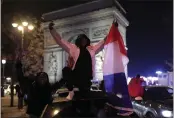  ?? LEWIS JOLY — THE ASSOCIATED PRESS ?? France supporters celebrate France's victory with French flags at the Arc de Triomphe after the World Cup semifinal match between France and Morocco on Wednesday in Paris. France defeated Morocco 2-0 and will head into Sunday's title match against Argentina.