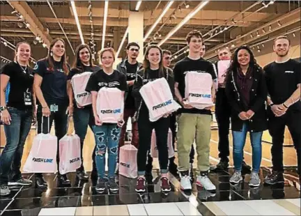  ?? PHOTO PROVIDED ?? Columbia High School’s Unified Basketball team is outfitted with free team shoes at the Finish Line in Crossgates Mall as part of the company’s annual holiday campaign November 16. The team has been selected to compete in the 2018Specia­l Olympics USA...