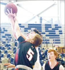  ?? PHOTO BY RICK PECK ?? McDonald County’s Boston Dowd and Webb City’s Alex Gaskill fight for a rebound during the Mustangs’ 71-49 loss on Saturday in the Kaminsky Classic at Joplin High School.