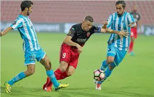  ?? — Photo by Dhes Handumon ?? Al Ahli’s Rodrigo Lima vies for the ball against Dibba’s Omar Ahmed and Ibrahim Abdullah during the AGL match in Dubai on Saturday.