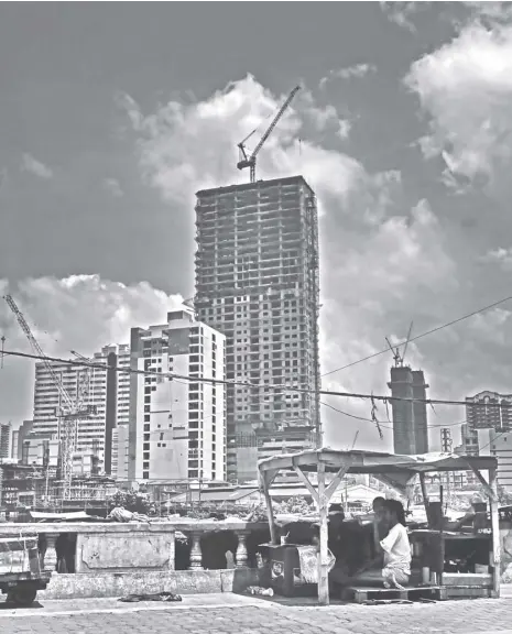  ?? NONIE REYES ?? A MAKESHIFT shelter housing a family of three on Delpan Bridge stands in stark contrast to the highrises undergoing constructi­on in the background. Despite the government’s efforts to boost human capital developmen­t through programs such as the Conditiona­l Cash Transfer and the Pantawid ng Pamilyang Pilipino Program, the Philippine­s continues to be a laggard in terms of the World Bank’s Human Capital Index among its Asean neighbors.