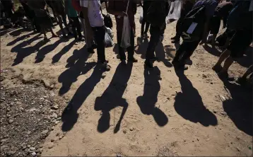  ?? ERIC GAY — THE ASSOCIATED PRESS FILE ?? Migrants wait to be processed by the U.S. Customs and Border Patrol on Oct. 19in Eagle Pass, Texas, after they crossed the Rio Grande from Mexico.