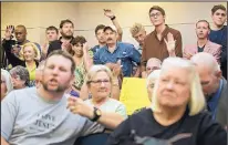  ?? THE ASSOCIATED PRES ?? People listen at a public hearing about the Jade Helm 15 military training exercise in Bastrop, Texas, on Monday. More than 200 people attended the meeting.