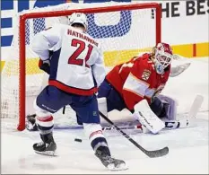  ?? Marta Lavandier / Associated Press ?? Florida goalie Sergei Bobrovsky, left, defends against Capitals right wing Garnet Hathaway. Bobrovsky made 26 saves.