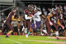  ??  ?? Pottsgrove’s Rahsul Faison looks for a running lane on Friday night against Phoenixvil­le.