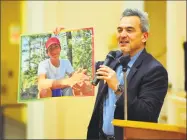  ?? Christian Abraham / Hearst Connecticu­t Media ?? Mike Song, whose son, Ethan, lost his life to an unsecured gun, holds up a photo of Ethan as he speaks during a gun violence vigil last month.