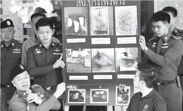  ??  ?? Policemen show pictures of body parts found in parcels as they address reporters in Bangkok. — Reuters photo