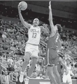  ?? Danny Moloshok Associated Press ?? KRIS WILKES scores 17 points to help lift the Bruins past Jordan Roberts and Long Beach State in their second game of the season.