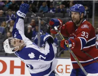  ?? RICK MADONIK/TORONTO STAR ?? IceCaps’ John Scott lays the lumber on Marlies’ Colin Smith during Toronto’s 5-3 victory Saturday at the ACC.