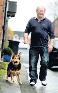  ?? Dominic Salter ?? Olly with owner Paul Fletcher. An Alsatian with dwarfism, he is just 14 inches tall