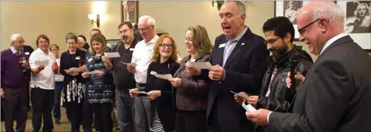  ?? BARB AGUIAR/Westside Weekly ?? West Kelowna Mayor Gord Milsom, right, swears in the the new Greater Board of Trade board at the January Business After Hours held at the Heritage Retirement Residence.