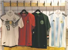  ?? AP FILE PHOTO ?? From left, national team jerseys of Germany, Portugal, Nigeria (away) and Argentina are on display at a shop in London.